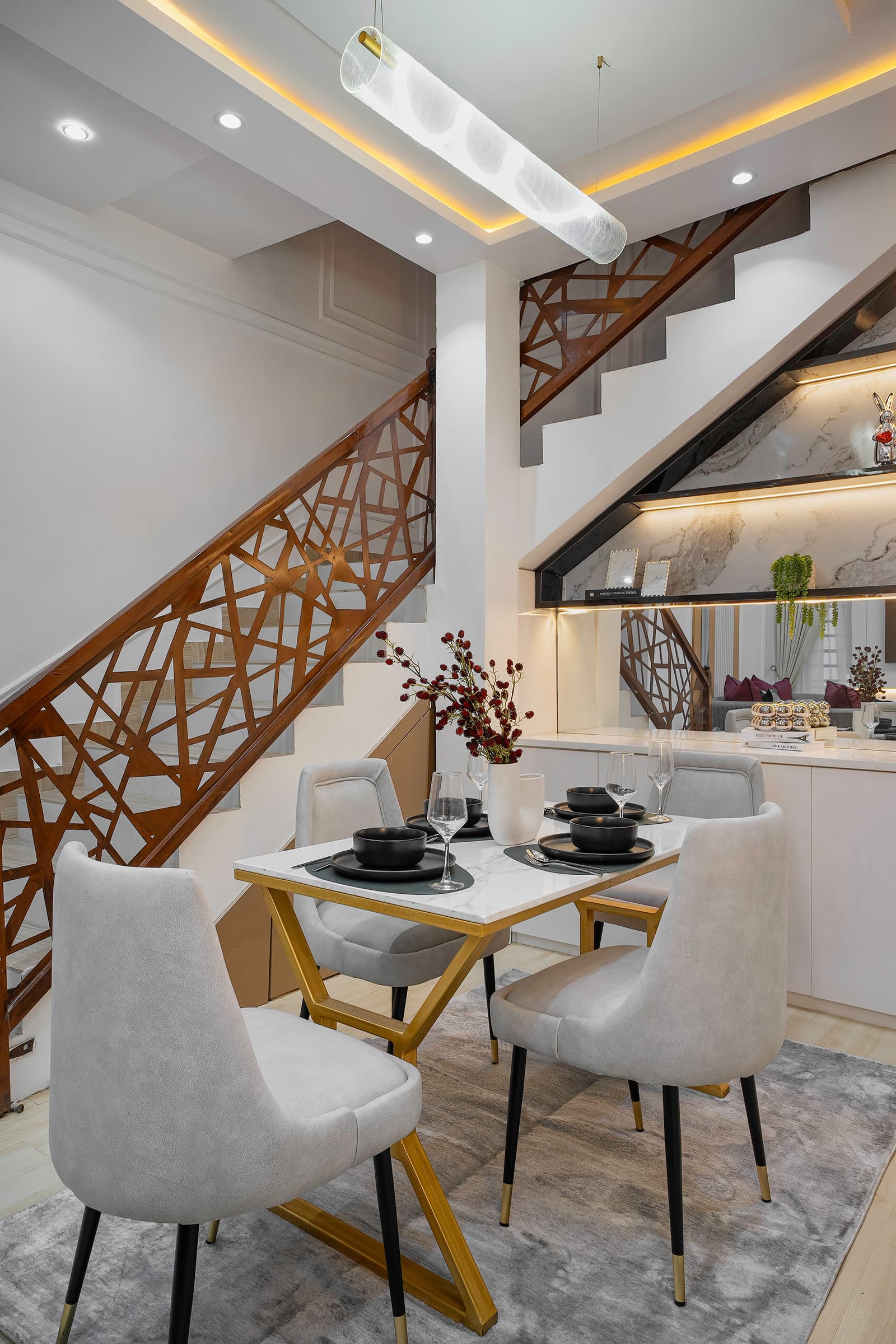 Looking down a curved staircase with glass pendant lights